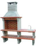 Barbacoa de obra con fregadero fabricada en cemento refractario y ladrillo.